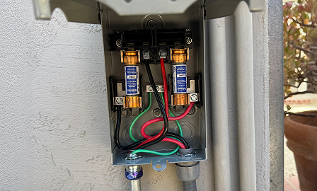 Outdoor AC maintenance by a technician.
