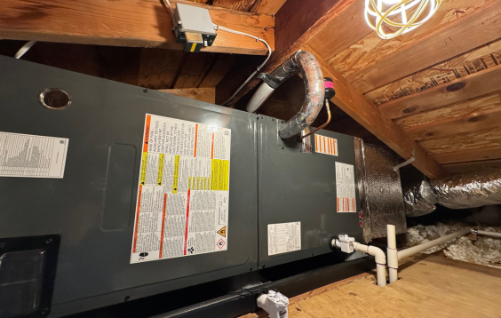Technician performing HVAC maintenance on an indoor unit.
